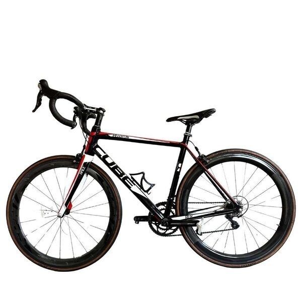 Black and red road racing bicycle with drop handlebars and bottle cage